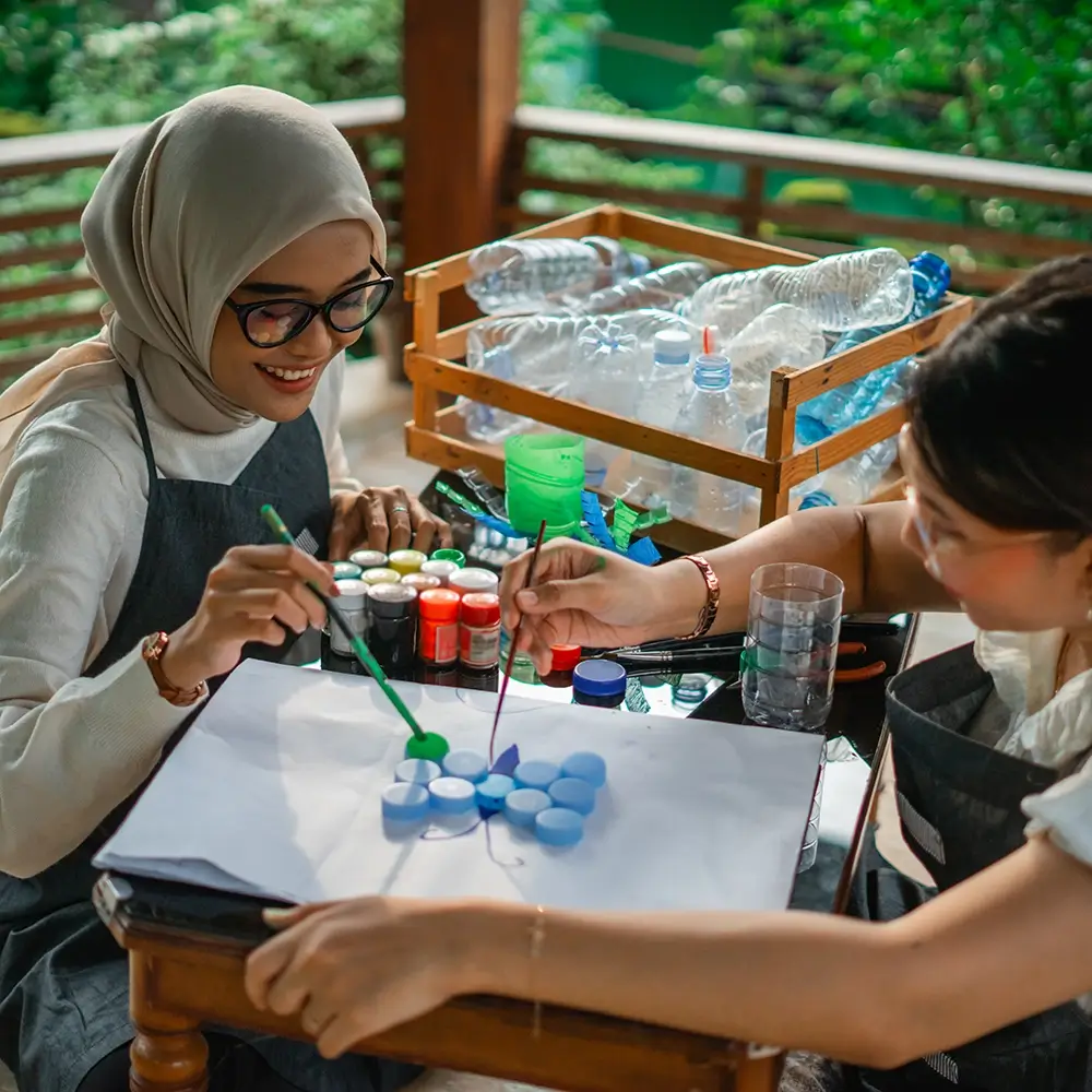 high-angle-view-asian-women-having-fun-painting-bottle-cap-together copy
